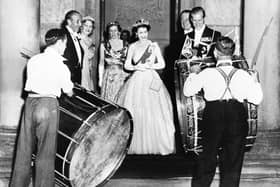 John Warden Brooke, 2nd Viscount Brookeborough (L), Queen Elizabeth II (C) and her husband Prince Philip, Duke of Edinburgh listen to drummers, on July 3, 1953 during their official visit to Northern Ireland.