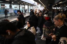 Commuters wait for an extremely delayed Central Line train at Stratford station in London on December 13  as rail strikes began a wave of festive walkouts in the country.