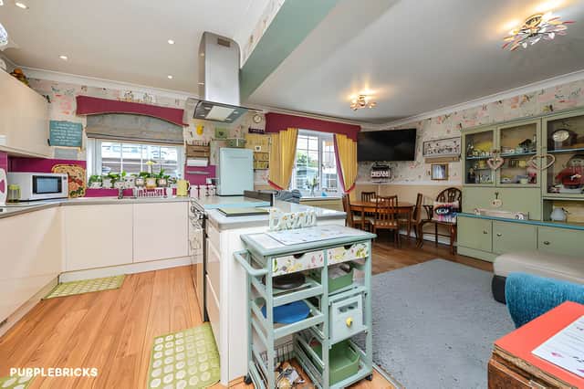 The modern kitchen and dining room has generous storage with space for family meals