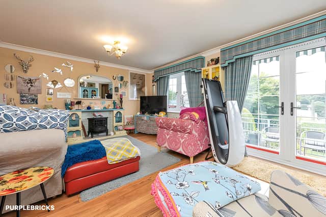 The lounge features laminate flooring and patio doors opening towards the front garden