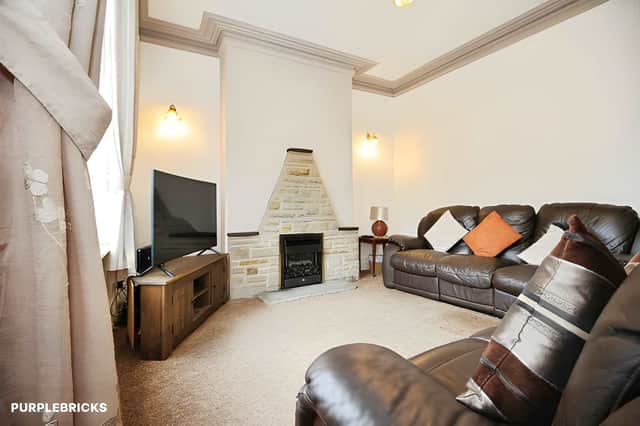 Modern décor, carpeted flooring and a gas fire set within an attractive surround give the lounge a comfortable focal point