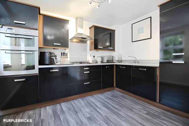 Modern fitted units, integrated appliances and space for a dining table make the kitchen/dining room a practical hub