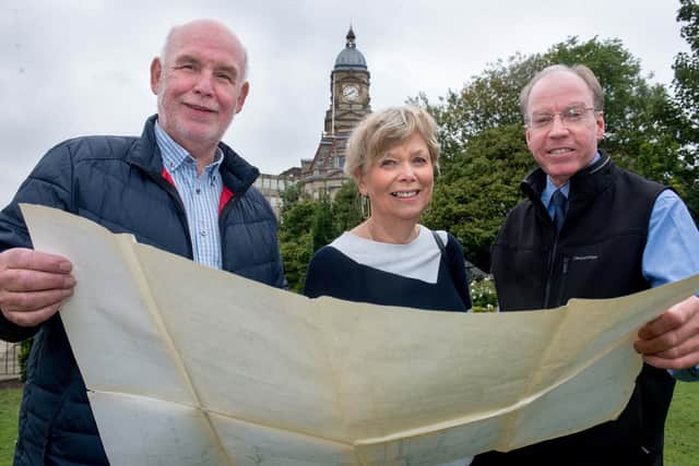 Councillor Eric Firth, (Lab, Dewsbury East) Marilyn Shaw, of Dewsbury Forward and Paul Ellis, President of the Dewsbury Chamber of Trade, look at plans for the mining monument.