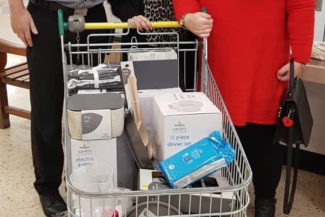 Simon Vickers, Morrison’s Heckmondwike Store Manager, Helen Perkin, Morrison's Heckmondwike People Manager, and Ann Parker, with the items that were donated to her father Norman.