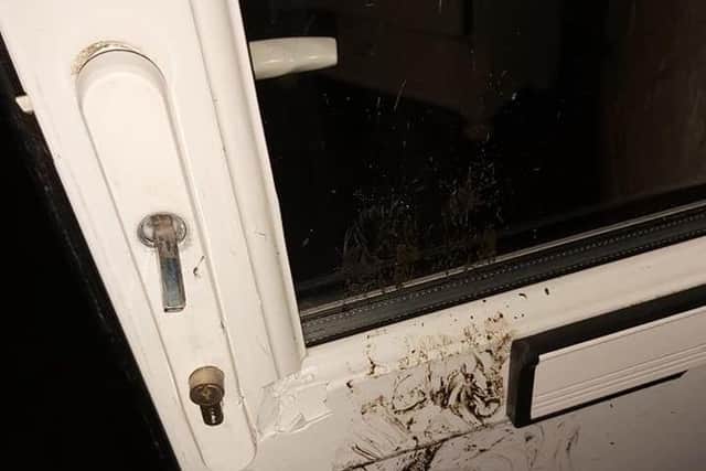 Damage to the rear door at the premises on Green Lane, Dewsbury