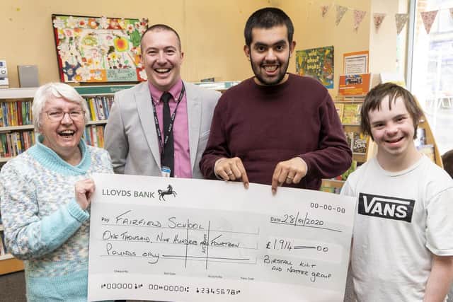 Elaine Jewell from Birstall Knit & Natter group presents a cheque to Steve Walsh, Pavendeep Singh and Liam Charlesworth from Fairfield School. Picture Scott Merrylees
