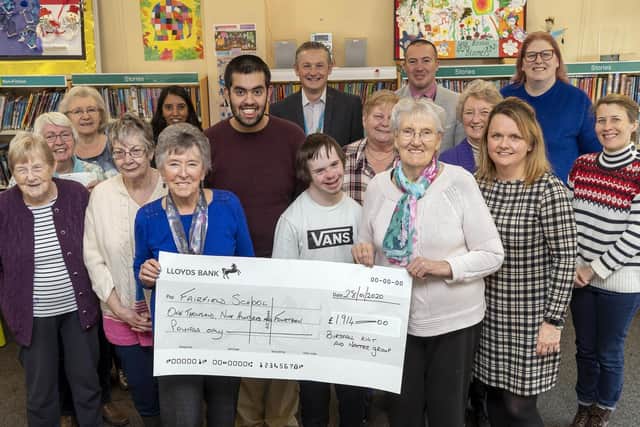 Birstall Knit & Natter group present a cheque to Fairfield School. Sarah Breeze pictured front row, far right