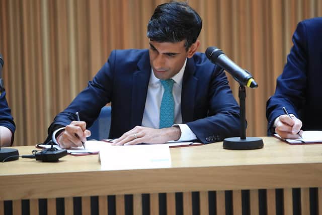Chancellor Rishi Sunak signs the West Yorkshire devolution deal in Leeds. Pic: Danny Lawson