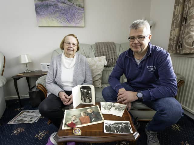 Beverley Greenwood with Mark Greenwood and the photos of her father-in-law and Mytholmroyd firefighter Clifford Greenwood. Photo by Allen McKenzie.