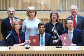 Chancellor Rishi Sunak and Minister Simon Clarke pose with West Yorkshire leaders as the devolution deal is signed. Pic: Danny Lawson PA