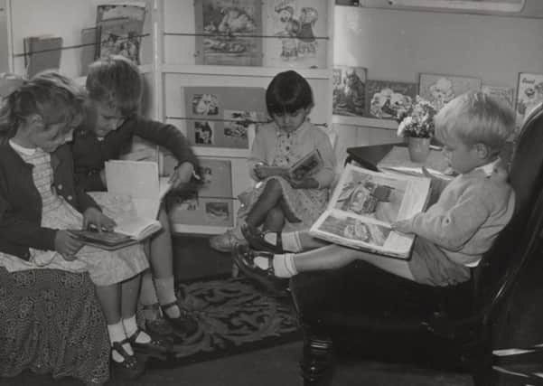 First for Dewsbury: Pictured are children who attended the new purpose-built nursery school built on the Flatts in Dewsbury in 1950. The teacher reading a story to them is Catherine Tarney, who has kindly loaned us this photograph.