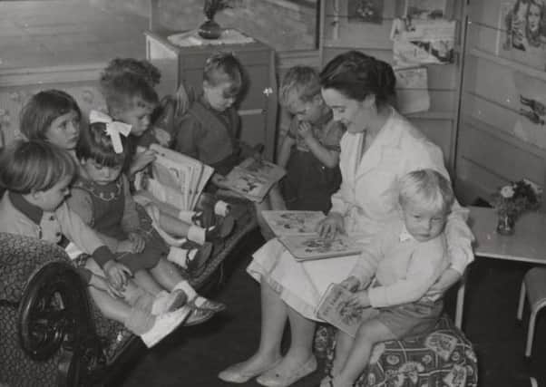 Flatts site: Pictured is Catherine Tarney, one of the teachers in Dewsbury’s first purpose-built nursery school, reading to some of the children in her care. The school, which is still there, was built on the Flatts, Dewsbury, in 1950, and although all the houses which once surrounded it have been demolished,  the school still retains its old name - Flatts Nursery School.