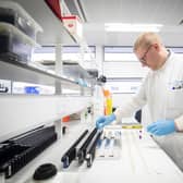 Clinical support technician extracts viruses from swab samples so that the genetic structure of a virus can be analysed and identified in the coronavirus testing laboratory at Glasgow Royal Infirmary (Photo by Jane Barlow - WPA Pool/Getty Images)