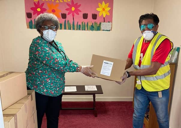 Vital support: Jame Mosque volunteers prepare to send out boxes to vulnerable residents.