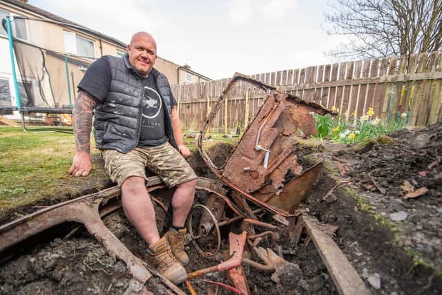 John Brayshaw, 40, unearthed a 1950s Ford in his back garden (Picture SWNS)
