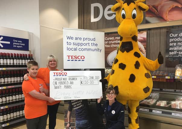 Research Cash: The Cleckheaton Tesco presentation to Norma Mazeika and her son Alfie. Photo submitted