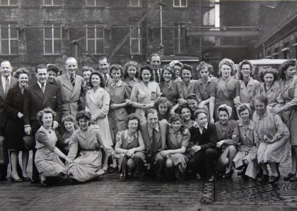 Rag mill roots: These workers pictured happily posing outside Wormald and Walker’s Mill in Thornhill Lees, long before it closed down in the 1980s, probably had no idea of the origins of the mill where they were working. Or that it had its roots in a medieval mill – Low Mill –which once stood nearby.