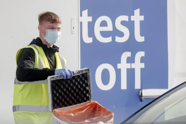 A worker at a Covid-19 driving in testing centre at Temple Green Park and Ride in Leeds, West Yorkshire. Photo: PA