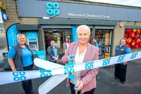 Customer Daphne Wilby cuts the ribbon to open the Co-op shop with Karen Rudge (store manager), Steph Pickles, Sue Wood, Michaela Farrar and Aly Tattersfield watching on.