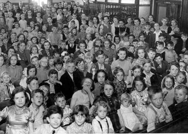 Party time: A picture to gladden the heart this Christmas. It shows the children who attended a Christmas Party during the early years of the war been organised by members of Eastborough Working Men’s Club, Dewsbury, for the children of their members. The club, which had one of the largest memberships in the district, closed some years ago.