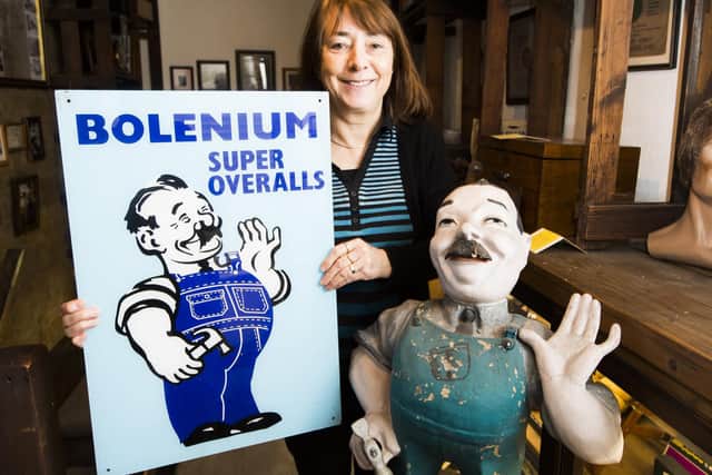 Sue Baker in the museum at John Greenwood's shop, Dewsbury, with the Bolenium Bill figure and sign.