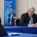 Prime Minister Boris Johnson speaks to members of staff as he visits a COVID-19 vaccination centre in Batley, (Getty Images)