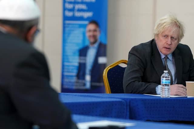 Prime Minister Boris Johnson speaks to members of staff as he visits a COVID-19 vaccination centre in Batley, (Getty Images)