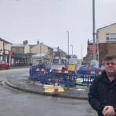 Cleckheaton councillor John Lawson in front of the 20m-high 5G telecommunications mast that has been put up in Scholes village. (Image: J Lawson)