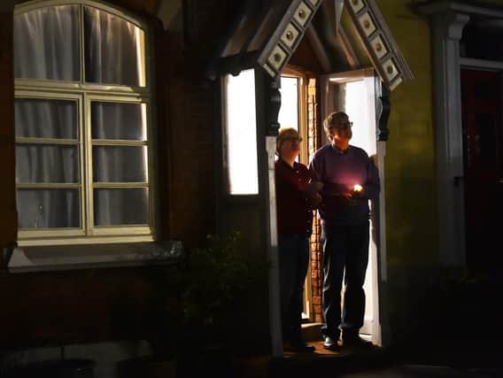 National Day of Reflection: People lit candles outside their homes to pay their respects. Photo: Getty Images