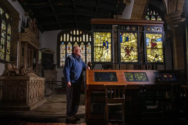 Brian Pearson, project manager at Thornhill Parish Church near Dewsbury, looks at the original 15th century medieval stained glass panels on show in the church. Pictures by Tony Johnson