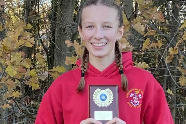 CHAMPION: Poppy Henson pictured with her award after winning the West Yorkshire Cross Country League championship.