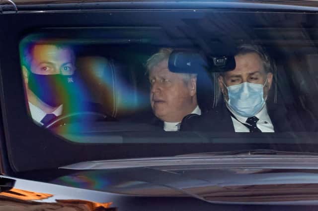 Prime Minister Boris Johnson is driven away from the House of Commons, after apologising for attending a lockdown-breaching party held in his Downing Street garden (Photo by TOLGA AKMEN/AFP via Getty Images)