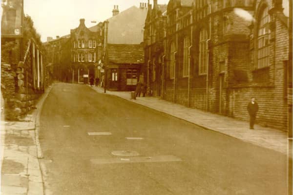 DEWSBURY: A rare picture of Wellington Road on a quiet day. You will need a magnifying glass to see the Turks Head pub on the right at the top of the picture on the corner of Nelson Street, once a busy thoroughfare. The library and swimming baths are clearly seen on the right.