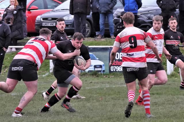 Determined defence from Cleckheaton as defenders aim to close down the space on Old Brodleians’ Dan Chappell. Picture: Robin Sugden