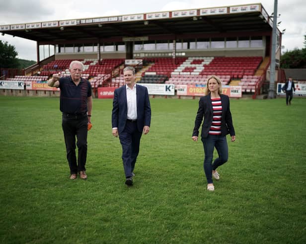 Batley Bulldogs' chairman Kevin Nicholas, left, and Kim Leadbeater MP, right, with Labour Party leader Keir Starmer on the pitch during a visit to Batley last summer