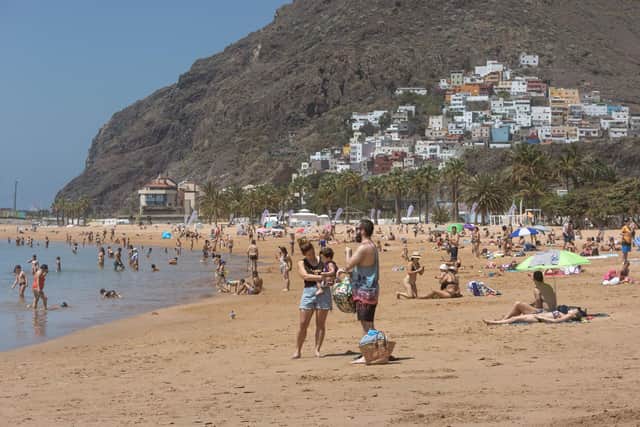 People sunbathing at Las Teresitas beach in the Spanish Canry Island of Tenerife.