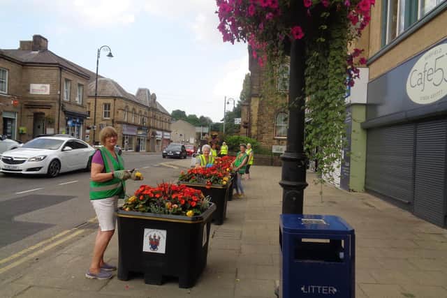 Watering planters in the town centre