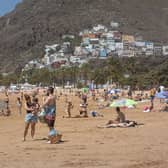 People sunbathe on Las Teresitas beach in Tenerife