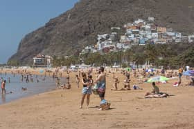 People sunbathe on Las Teresitas beach in Tenerife