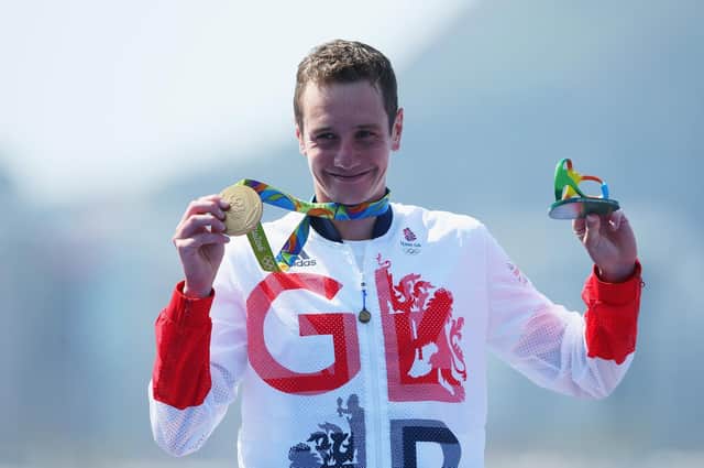 Alistair Brownlee celebrates on the podium during the Men's Triathlon at the 2016 Rio Olympic Games.