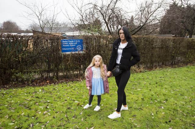 Talor Hartshorne with five-year-old daughter Maisie outside Batley Parish J, I & N School