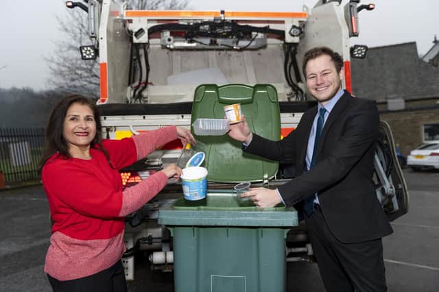 Councillors Naheed Mather and Will Simpson show Kirklees residents which new plastics can go in their bins from March 31