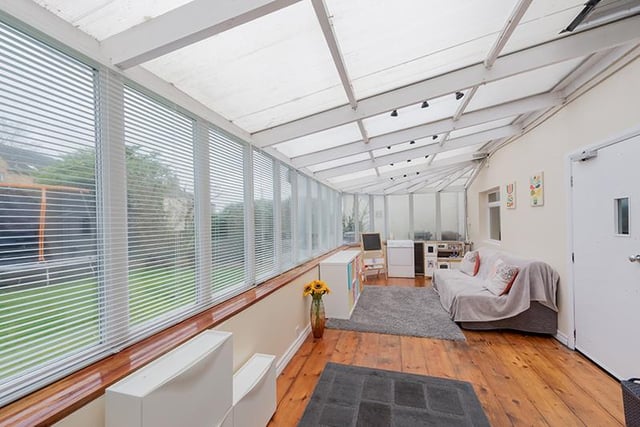 This conservatory runs along the back of the property, overlooking the garden.