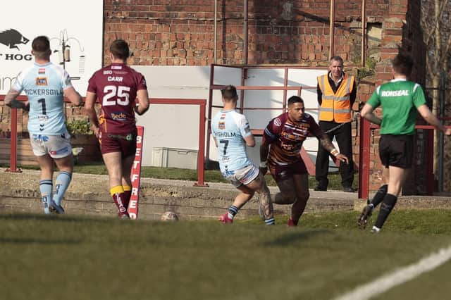 Greg Johnson turns round to celebrate after scoring the opening try of the game for Batley Bulldogs against Featherstone Rovers. Picture: Neville Wright