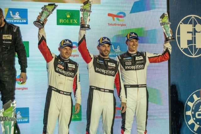 Inception drivers Ollie Millroy, Brendan Iribe and Ben Barnicoat stand on the podium after the 1000 Miles of Sebring race.
