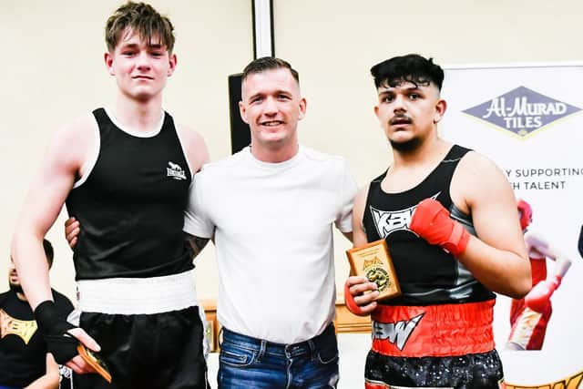 Logan Bramwell (right) with opponent Lewis Sampson and professional boxer Darren Tetley who handed out trophies to the fighters.