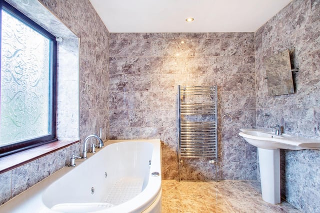 A spa bath is a feature within the family bathroom.