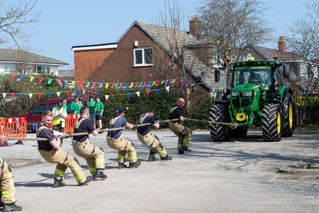 Mirfield firefighters working together to pull the tractor.