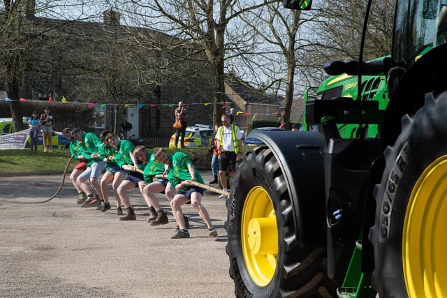 Penistone Young farmers working together to pull the tractor.