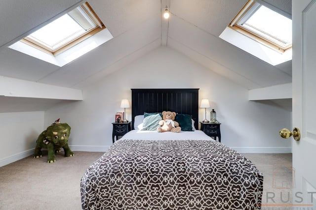 A quirky second floor bedroom with skylight windows.